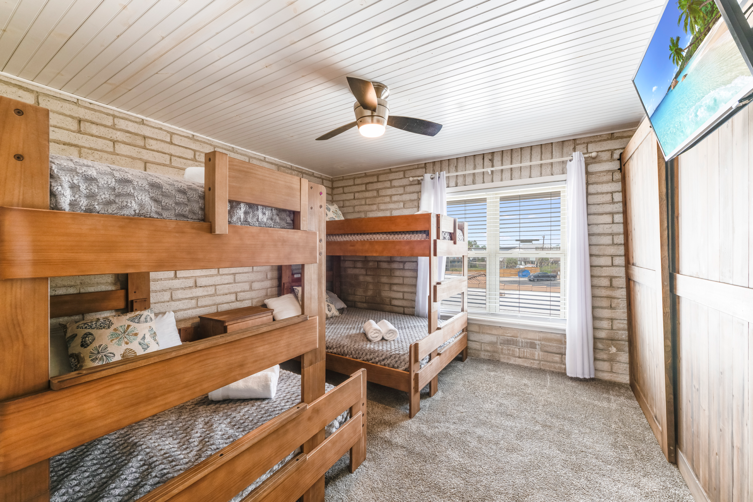 Bunk room with twin-over-full bunks in Port Aransas condo, part of 6-bed layout that sleeps up to 10 guests